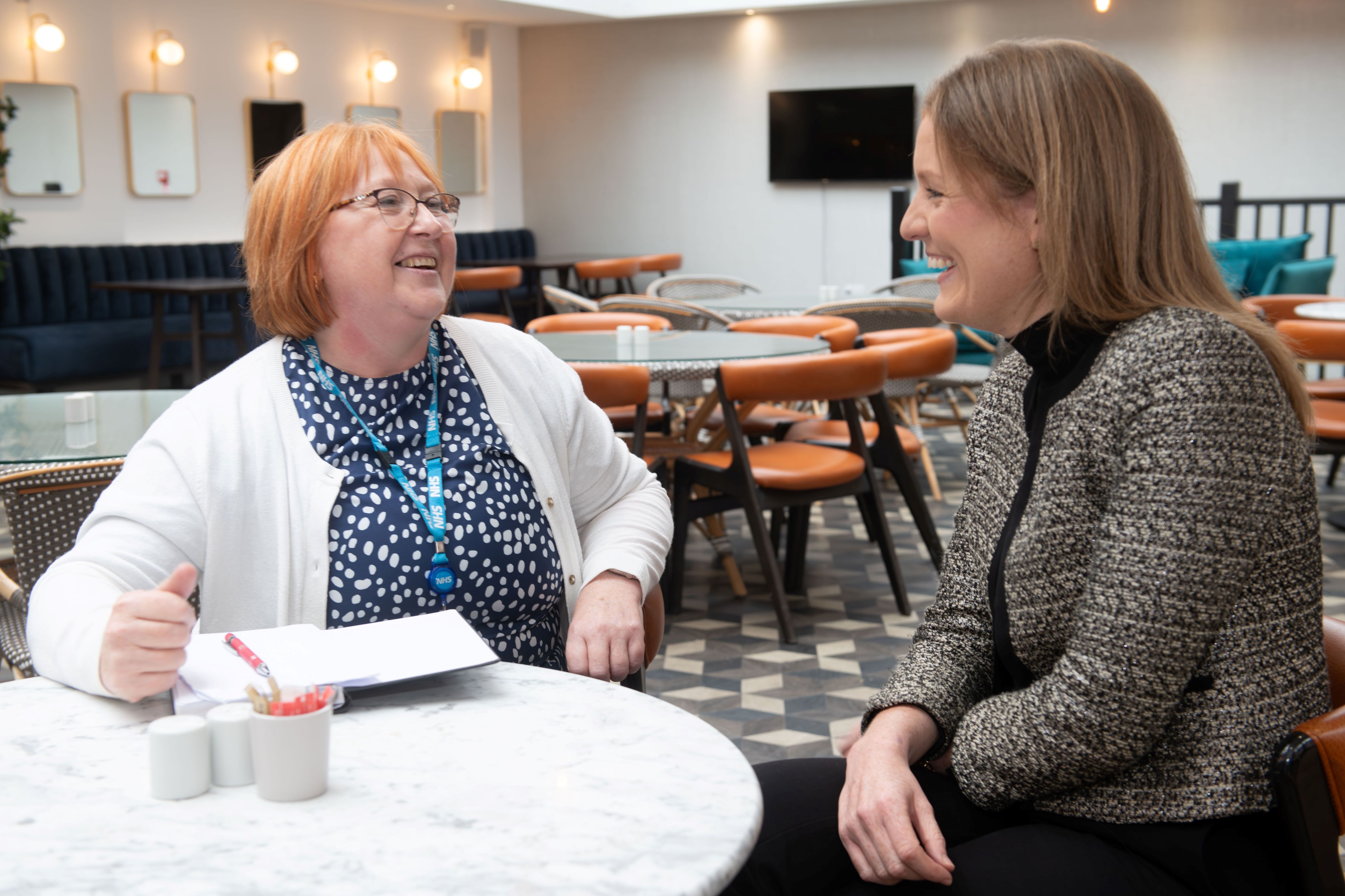 Jayne Richardson and Chantal Kinsella sat talking at a table.