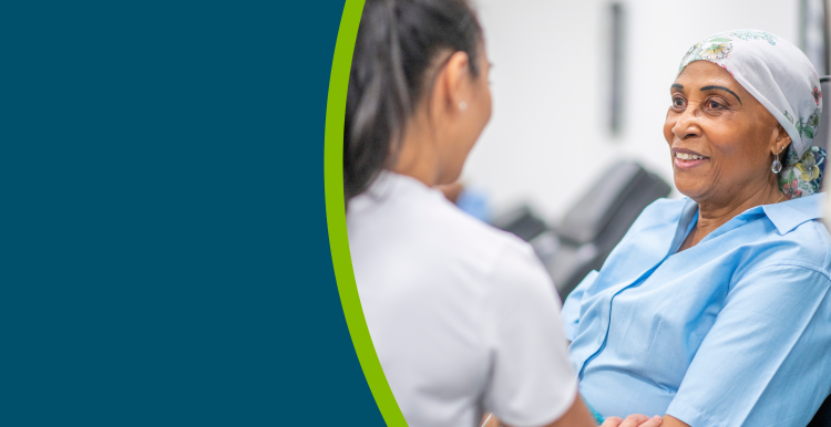 A cancer patient in hospital, speaking with a healthcare professional.