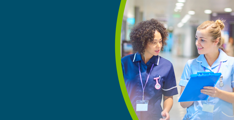 Two nurses in a hospital corridor.