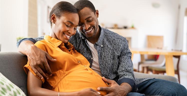 Expectant mother and father holding her tummy in readiness for a new baby