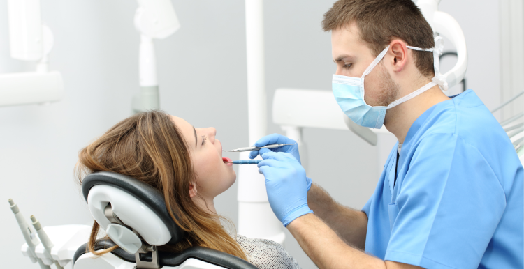 Dentist performing a check up on a patient