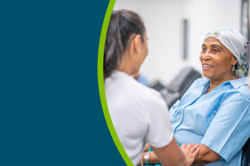 A cancer patient in hospital, speaking with a healthcare professional.