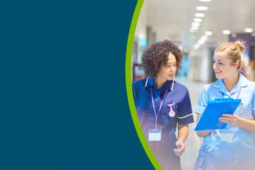 Two nurses in a hospital corridor.