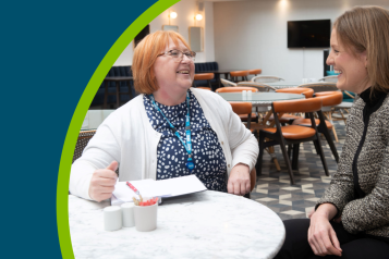Jayne Richardson, a registered manager legacy mentor, sits at a table talking with Chantal Kinsella, who is the founder and manager at Bronte House Group, a bespoke homecare provider for older people, with a specialist focus on dementia care.