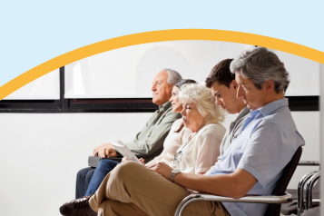 A group of people sat in a hospital waiting room.
