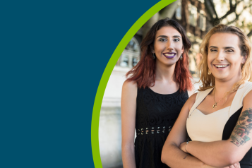 Two trans and non-binary people smiling