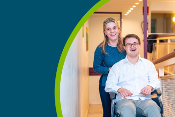 Happy portrait of a caregiver and man with down syndrome on wheelchair