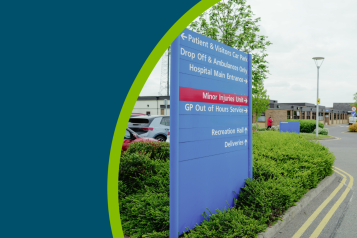 Hospital sign pointng toward patient and visitors car park, drop off, main hospital entrance, minor injuries unit, GP out of hours service