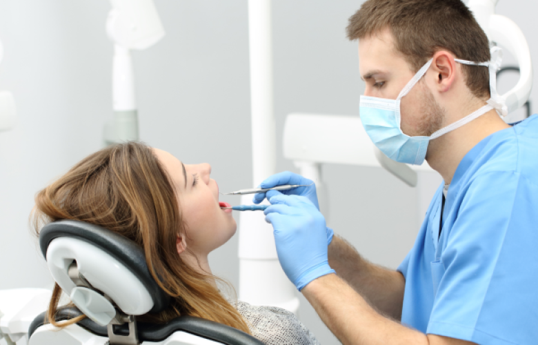 Dentist performing a check up on a patient